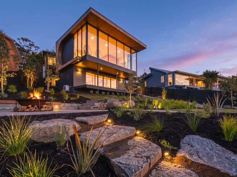 Terraced native garden with stone steps and lighting at the same modern home, after